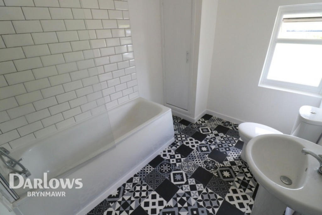 Refurbished bathroom with subway tiles and patterned floor