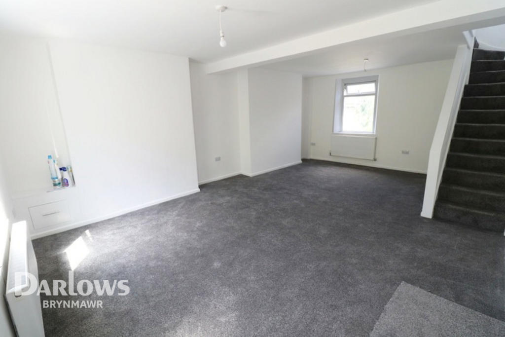Refurbished living room with new grey carpet and white walls